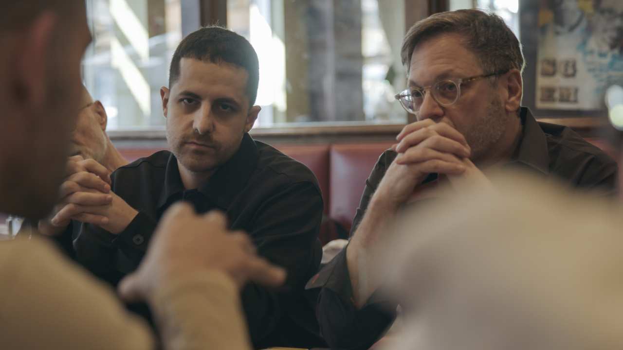two men sitting together at a table